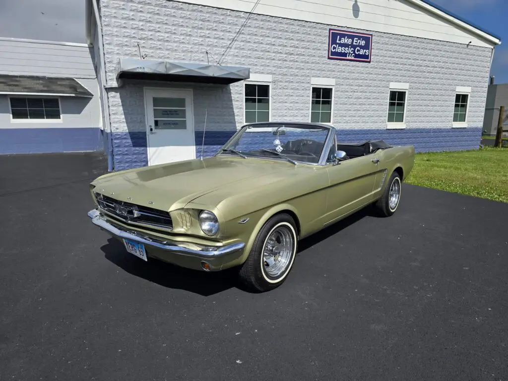 Vintage convertible car at classic car dealership.