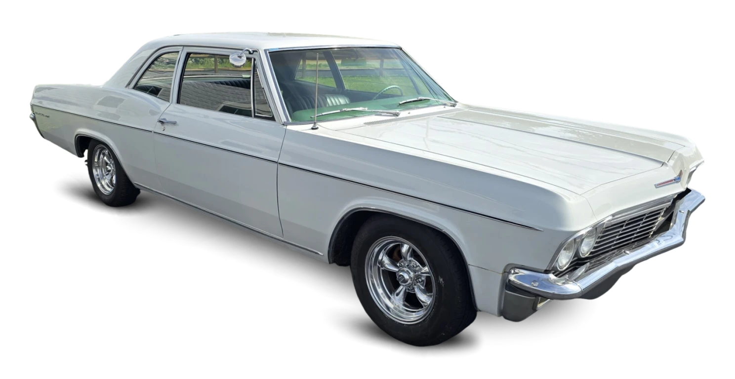 White classic car on black background.